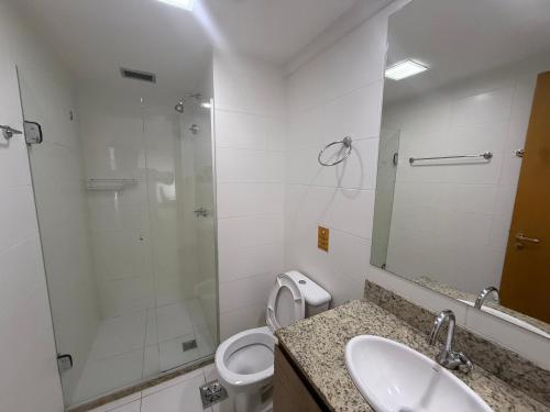 a bathroom with a shower and a toilet and a sink at Saint Moritz Hotel - ALM Hospedagens - Flat Particular in Brasilia