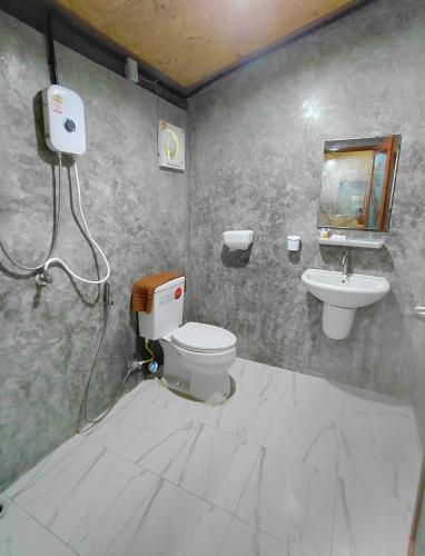 a bathroom with a toilet and a sink at Nathan Breeze Resort in Ko Muk
