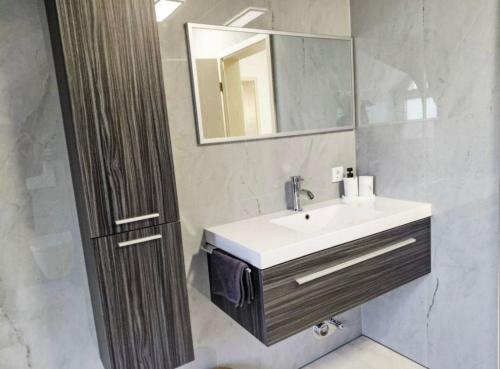 une salle de bain avec un lavabo et un miroir dans l'établissement Ferienwohnung Sonnenschein, à Bad Pyrmont
