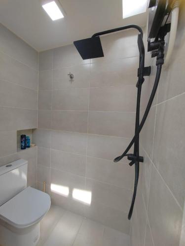 a shower in a bathroom with a toilet and a light at Zen Retreat KL in Kuala Lumpur