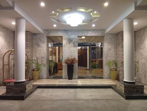 a lobby of a building with columns at Vinpy hotels in Uyo