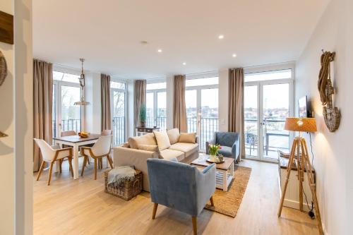 a living room with a couch and a table at Dockside Travemünde in Travemünde