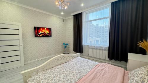 a bedroom with a bed and a window at Expo New Life Astana in Astana