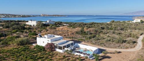 an aerial view of a house with the ocean in the background at Magia's Residence in Naousa