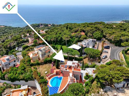 an aerial view of a house with the ocean in the background at Villa Irene in Castiglioncello by TuscanyWeGo in Chioma