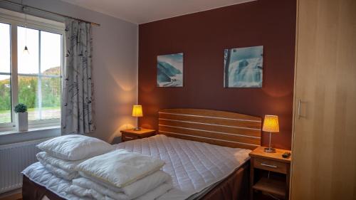 a bedroom with a bed with two pillows on it at Apartments Klövsjöfjäll in Klövsjö