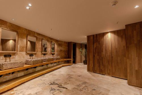 a bathroom with a row of sinks and mirrors at The Brown, Guatape, Autograph Collection in Guatapé