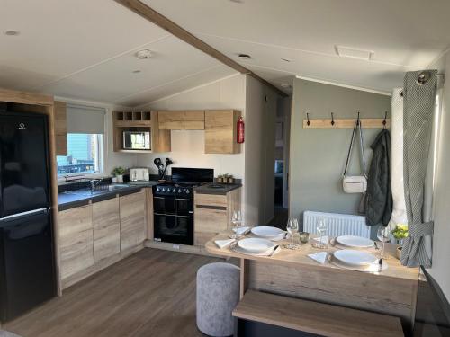 a kitchen with a table with plates on it at 2025 Willerby Ellerton Static Caravan in Morecambe