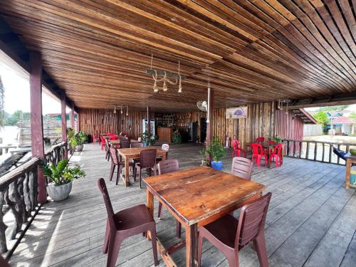 a wooden patio with tables and chairs on a deck at Koh Rong 71 Guesthouse in Koh Rong Island