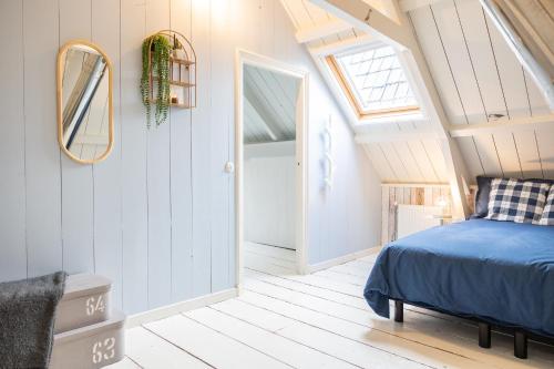 a bedroom with a bed in a attic at Karakteristieke boerderij met wellness in Friesland in Suameer