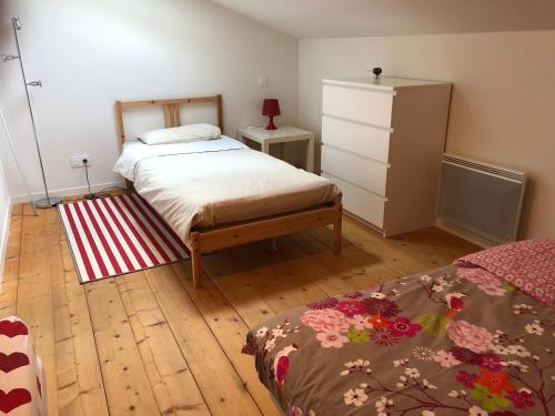 a bedroom with a bed and a dresser at Gites Gayet in Fours