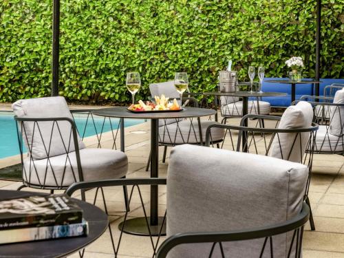 a group of tables with chairs and glasses of wine at Pullman Santiago Vitacura in Santiago