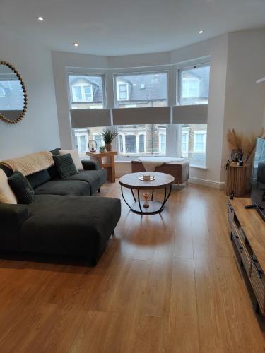 a living room with a couch and a table at luxury Maisonette near beach in Morecambe