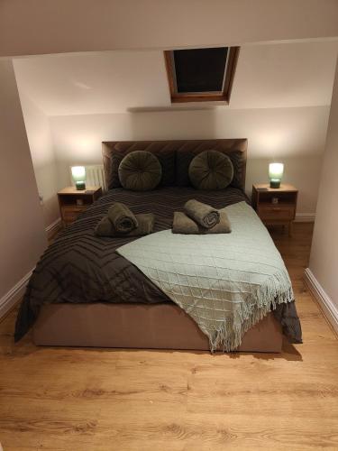 a bedroom with a large bed with two night stands at luxury Maisonette near beach in Morecambe
