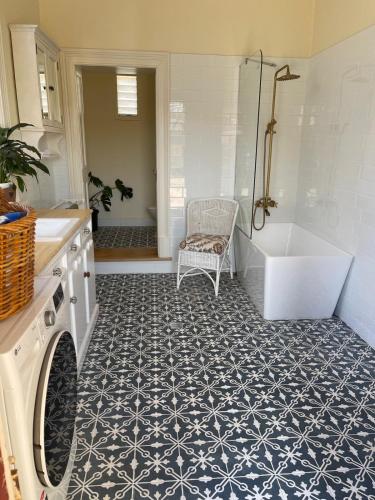 a bathroom with a tub and a toilet and a sink at The Gilded Hare in Moonta in Moonta