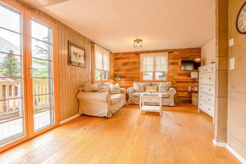 a living room with two couches and two windows at Reste Fidèle Duplex in Fiesch