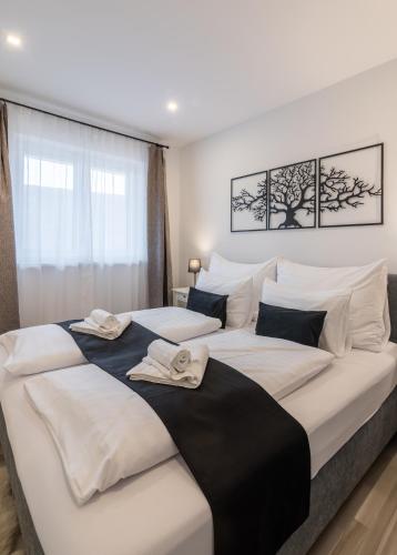 a bedroom with two beds with towels on them at Secret Collection Thermenresort in Frauenkirchen