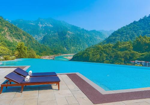 a bench sitting on a patio next to a swimming pool at Luxury Aloha Apartments, Rishikesh in Rishīkesh