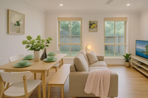a living room with a couch and a table at Sunnybank Hills Haven - Family Comfort Retreat in Brisbane