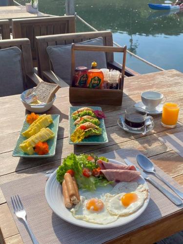 a table with a plate of breakfast food on it at Moana Resort Koh Kood in Ban Lak Uan