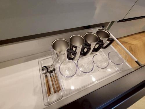 a bunch of utensils sitting on top of a stove at ローズパーク十番館 in Narashino