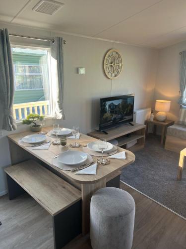 a living room with a table and a tv at 2025 Willerby Ellerton Static Caravan in Morecambe