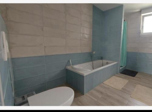 une salle de bain avec toilettes, baignoire et lavabo dans l'établissement Résidence Abyssia, à Ensisheim