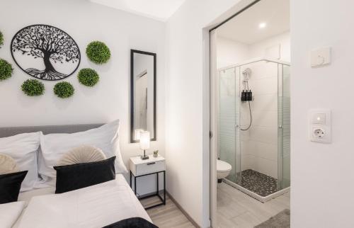 a bedroom with a bed and a shower and a toilet at Secret Collection Thermenresort in Frauenkirchen