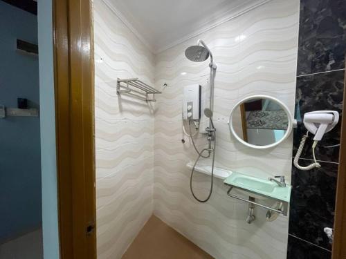 a bathroom with a shower and a mirror at Saujana City Hotel - Nearby KLIA in Bandar Saujana Putra