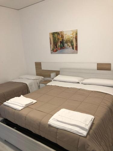 a room with two beds with towels on them at Locanda del Musso con Ristorante in Adria