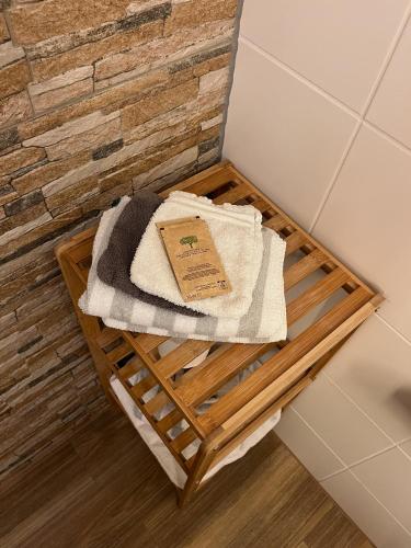 a wooden tray with towels and a book on it at Hotel Restaurant Alte Post in Meersburg