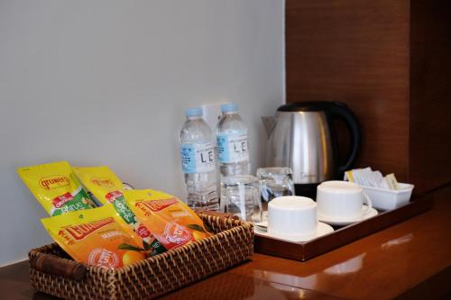 a table with two baskets of food and bottles of water at Lex Hotel Cebu in Cebu City