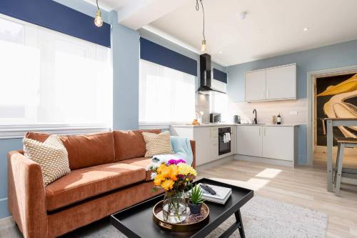 a living room with a couch and a table at Apartment Seven Pelican House in Bournemouth