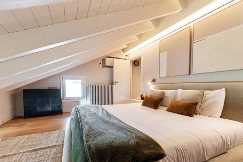 a bedroom with a large bed in a attic at Once in a Lifetime - by MyHomeInComo in Laglio