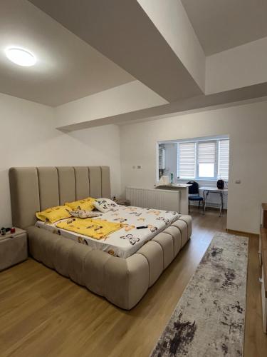 a large bed in a room with a large mattress at DecoStudio in Craiova