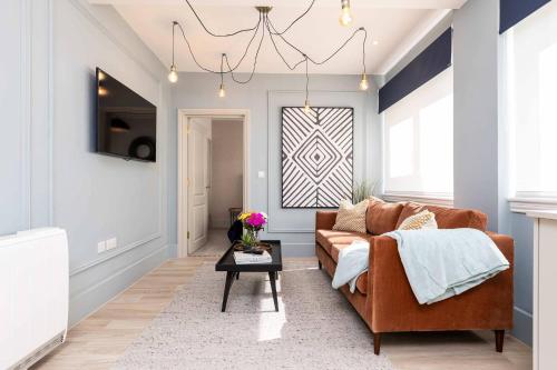 a living room with a couch and a table at Apartment Seven Pelican House in Bournemouth