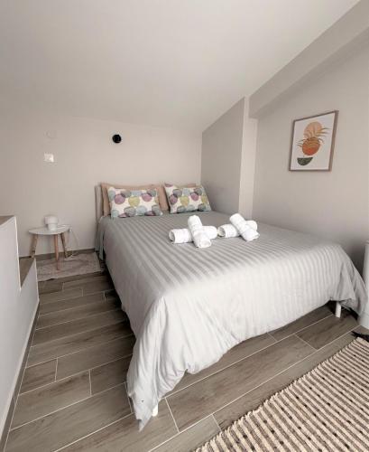 a bedroom with a large bed with towels on it at Panorama Sunvilles Apartment 6 in Thessaloniki