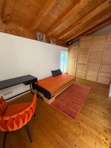 a bedroom with a bed and a desk and a chair at Haus am Obstanger in Traunstein