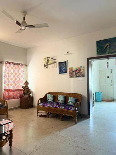 ein Wohnzimmer mit einer Couch mit Kissen darauf in der Unterkunft Just for womens homestay in Chikmagalur