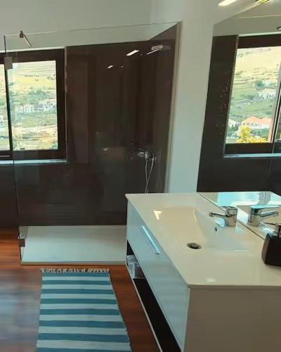 a bathroom with a sink and a mirror at Quinta do Santo no Douro - Casa T2 in Alcarias