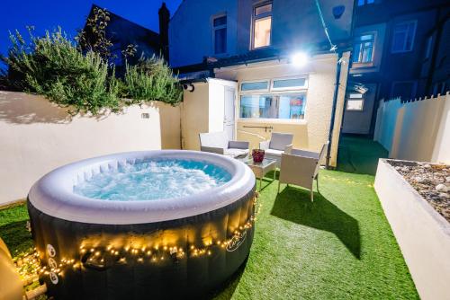 a hot tub in the backyard of a house at 4BR 2Bath Home -Hot Tub, Free Parking & Games Room in Cardiff