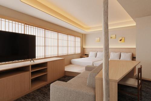 a hotel room with a bed and a flat screen tv at Hotel Fork & Knife Miyajima in Miyajima