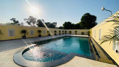 a swimming pool in the courtyard of a building at Umrao Mahal - A Boutique Heritage Hotel & Resort Jaipur in Jaipur
