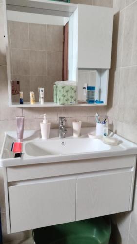 a bathroom with a white sink and a mirror at Unique and quiet TROPICKÝ PRÁZDNINOVÝ DŮM in Punta Cana