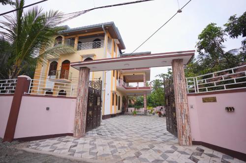 a house with a gate in front of it at Palm Villas Jaffna in Jaffna