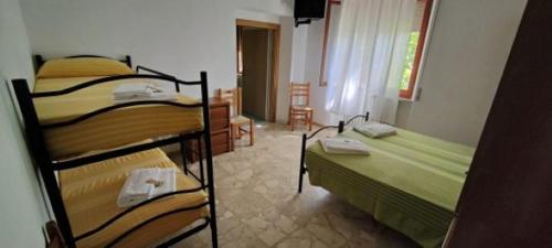 a room with two bunk beds in a room at Country House UNA in Cupra Marittima