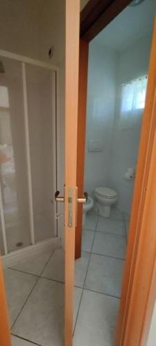 an open door to a bathroom with a toilet at Country House UNA in Cupra Marittima