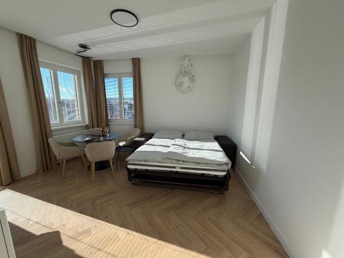 a bedroom with a bed and a table in it at Lumio in Košice