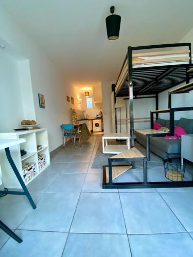 a living room with a couch and a loft bed at Studio proche Côte des Basques in Biarritz