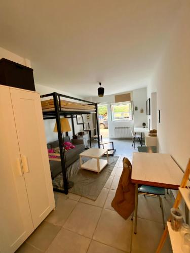 a living room with a couch and a table at Studio proche Côte des Basques in Biarritz